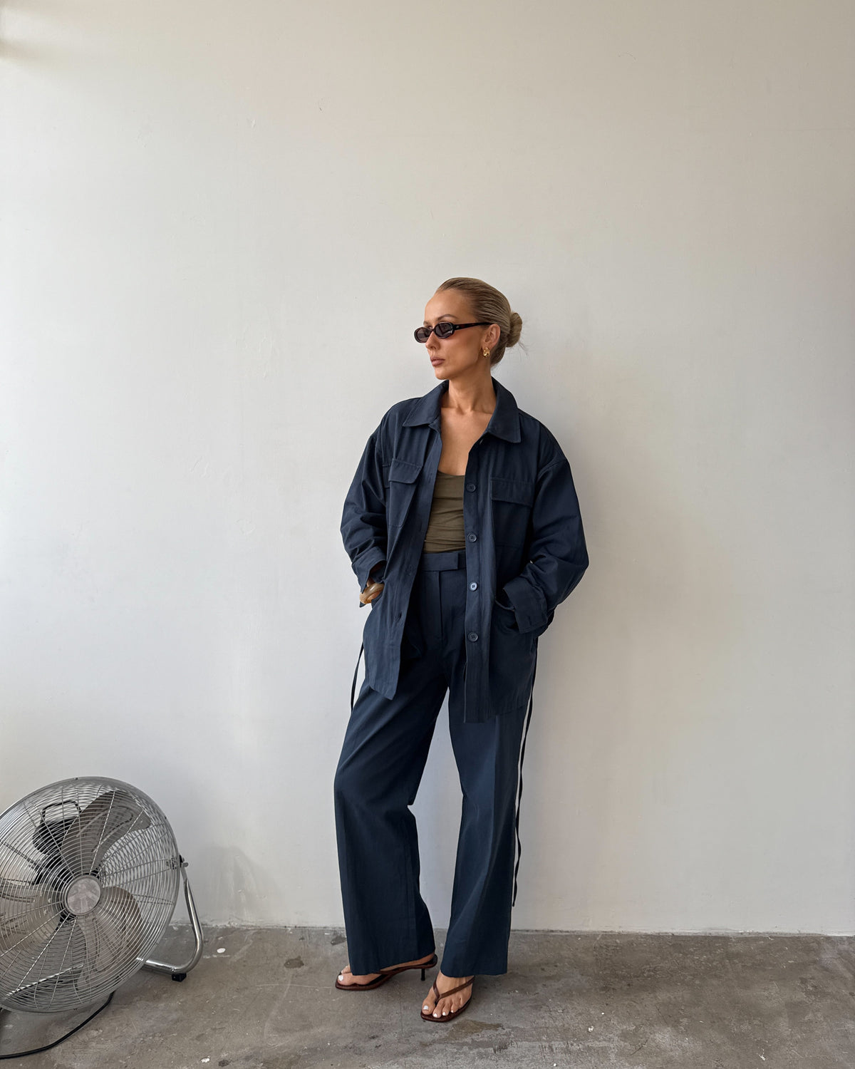 Model against a white background wearing a navy blue outfit