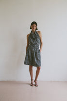 Model wearing a plaid set including a halter neck top and wide leg knee length shorts