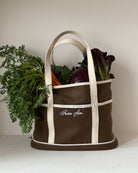 Brown and white tote bag with vegetables