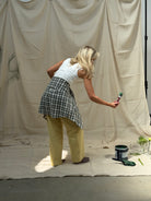 Person painting a large sheet with a brush 