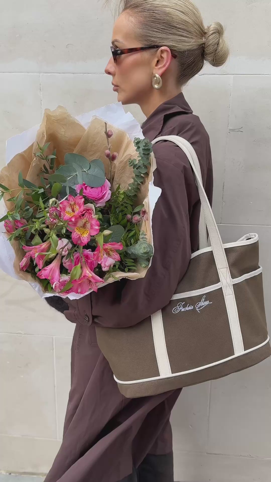 Model wearing a brown and white tote, outside, in a art museum and in a supermarket